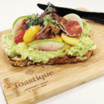 toastique healthy franchises toast on wooden chopping board