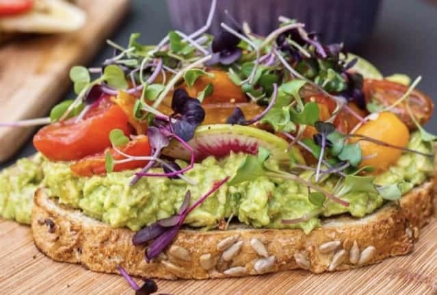 Toastique healthy franchise toast on wooden chopping board.